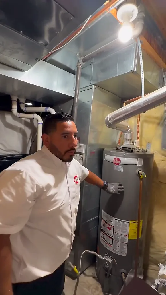 technician next to water heater